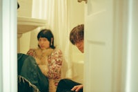 a man and a woman sitting in a bathroom